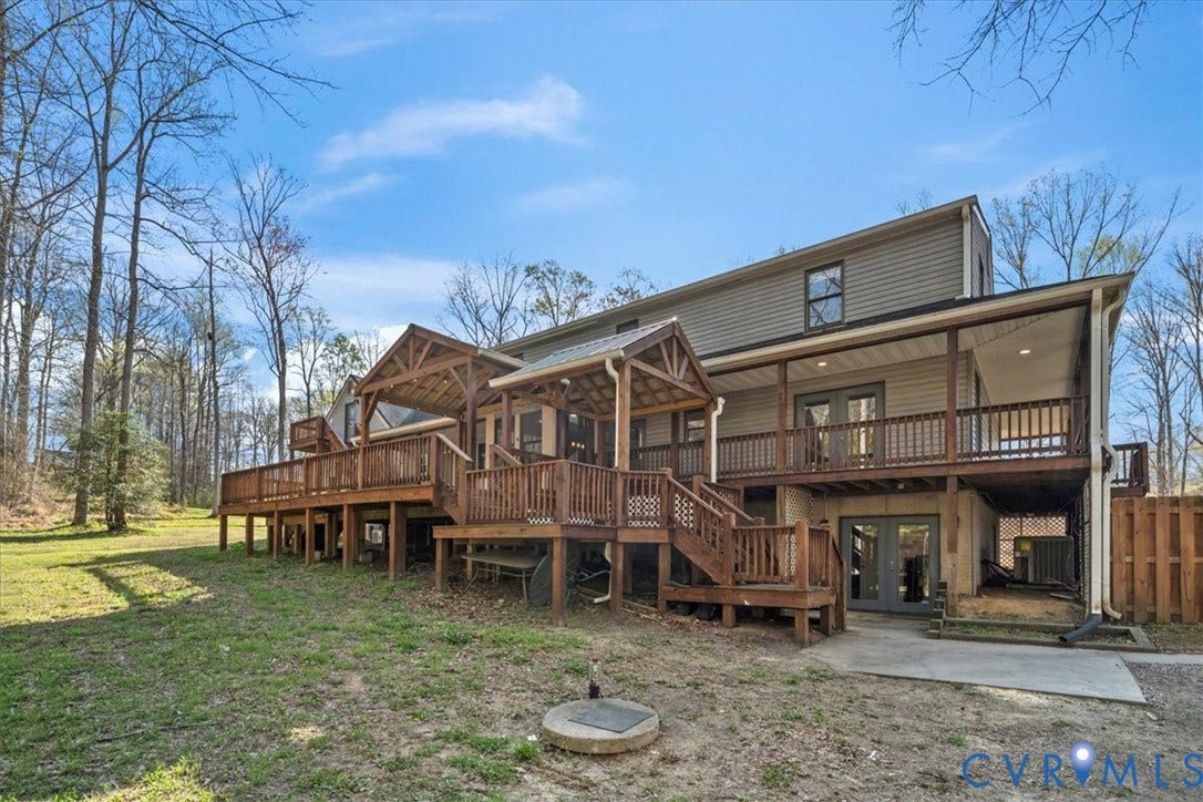 7040 Old Roxbury Road, Average, New Kent, VA 23141 Multi-level wood deck featuring a covered timber-framed patio, decorative railings, and stairs