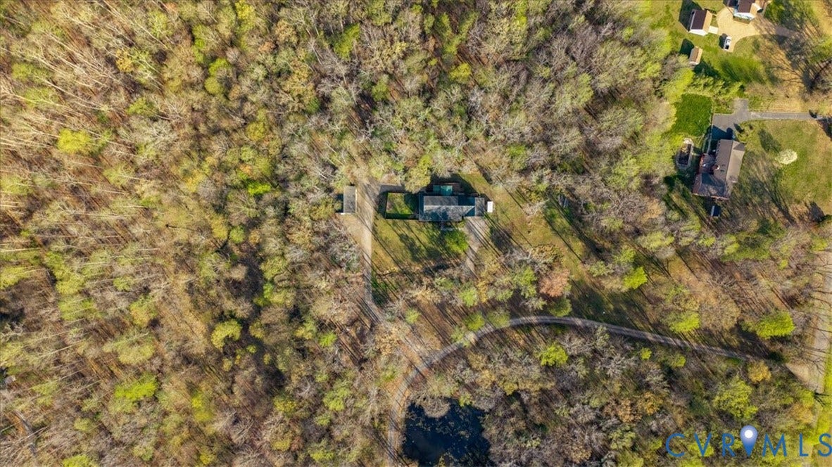 7040 Old Roxbury Road, Average, New Kent, VA 23141 Aerial perspective of a multi-structure property featuring dense perimeter woodland, a paved driveway, and an expansive parcel