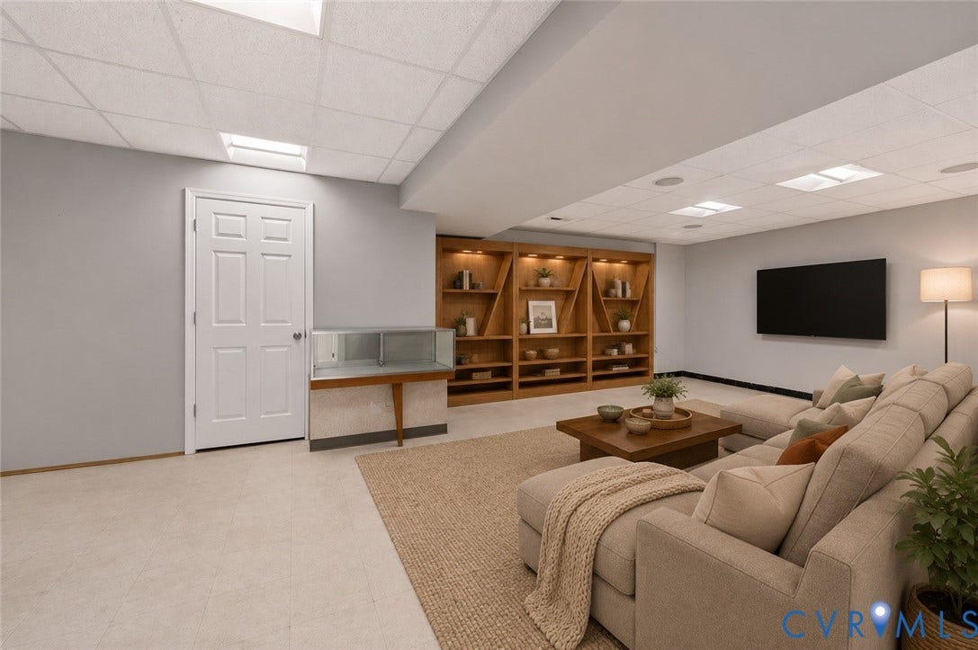 7040 Old Roxbury Road, Average, New Kent, VA 23141 Finished interior space featuring a drop ceiling with recessed lighting, custom built-in wooden shelving with integrated accent lighting, and a six-panel interior door