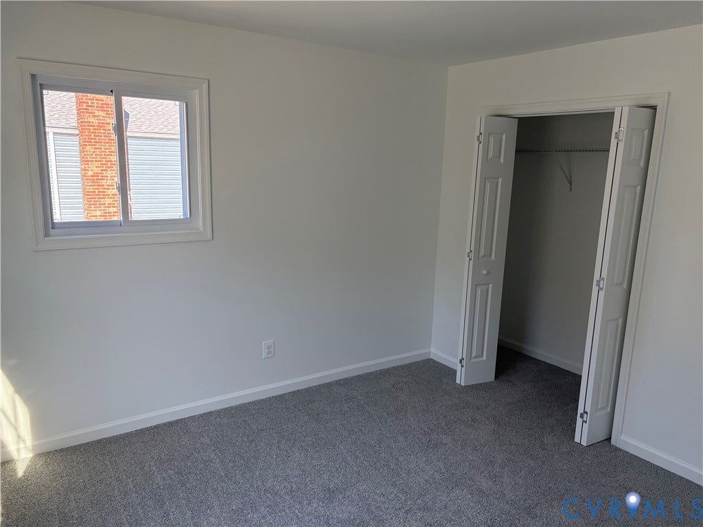 1708 Shewalt Drive, Fairfield, VA 23228 Bedroom 3 featuring neutral-toned carpeting, single-pane sliding window, and a built-in closet with six-panel bifold doors