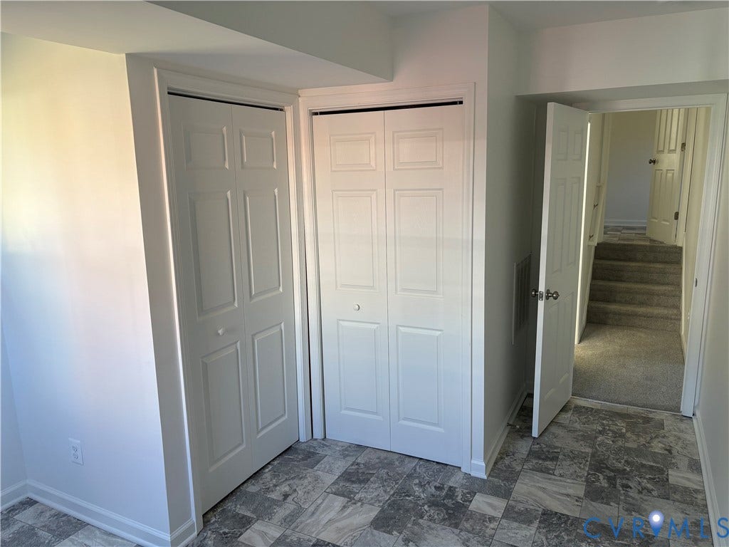 1708 Shewalt Drive, Fairfield, VA 23228 Neutral-toned multi-format flooring, two sets of white six-panel bi-fold closet doors, and interior paneled doors