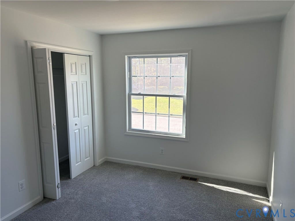 1708 Shewalt Drive, Fairfield, VA 23228 Bedroom 2 Neutral interior space featuring neutral wall paint, carpeted flooring, a grid-patterned window, and a white bifold closet door