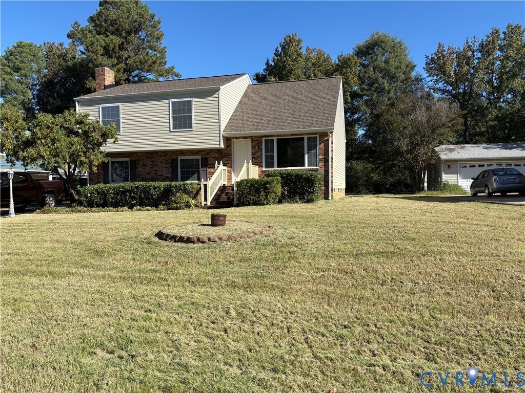 1708 Shewalt Drive, Fairfield, VA 23228 Split-level exterior featuring a brick and siding facade, chimney, shingled roof, and a detached garage