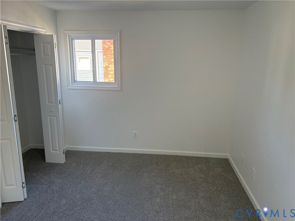 1708 Shewalt Drive, Fairfield, VA 23228 Primary Bedroom Neutral-toned carpeting, single-hung vinyl window, and double-panel closet door