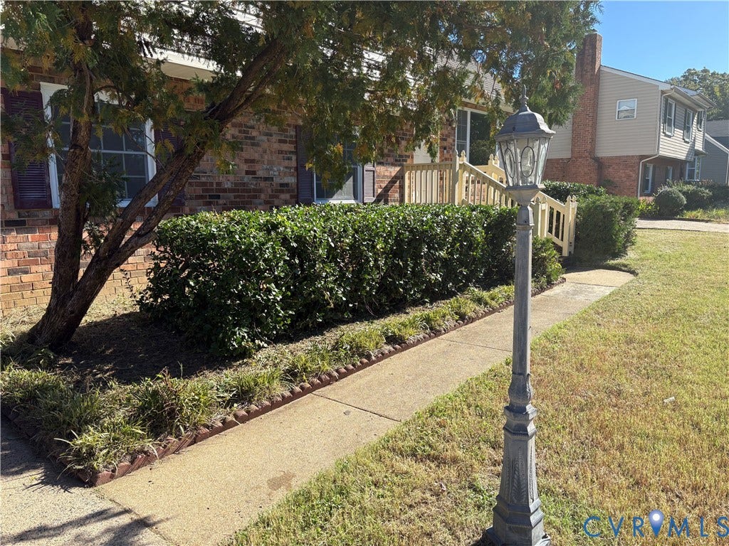 1708 Shewalt Drive, Fairfield, VA 23228 Brick exterior featuring a concrete walkway, decorative metal post light, and built-in railing