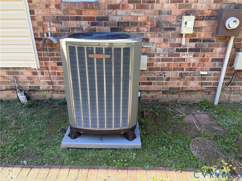 1708 Shewalt Drive, Fairfield, VA 23228 Trane central air conditioning unit mounted on a concrete slab against a red brick exterior