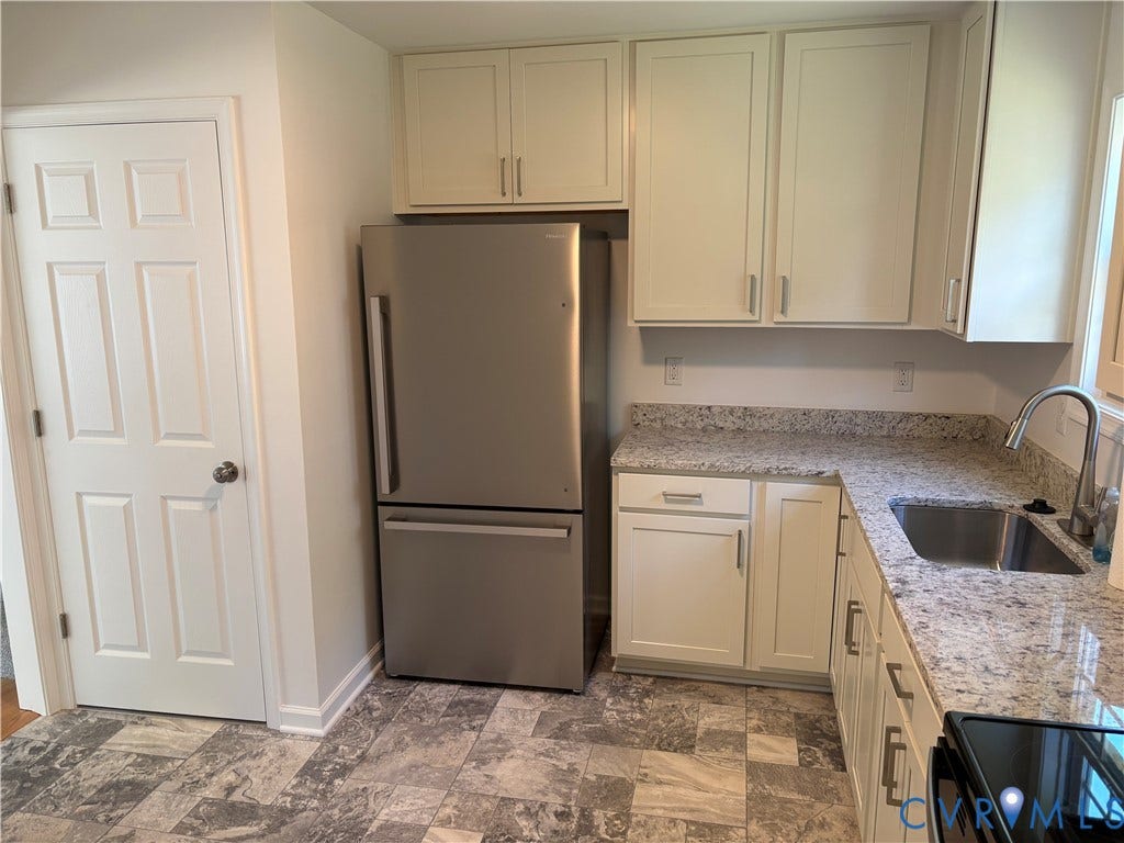 1708 Shewalt Drive, Fairfield, VA 23228 Kitchen featuring light-toned shaker cabinetry, stone-finish countertops, stainless steel undermount sink with arched pull-down faucet, stainless steel bottom-freezer refrigerator, and multi-tone tile flooring