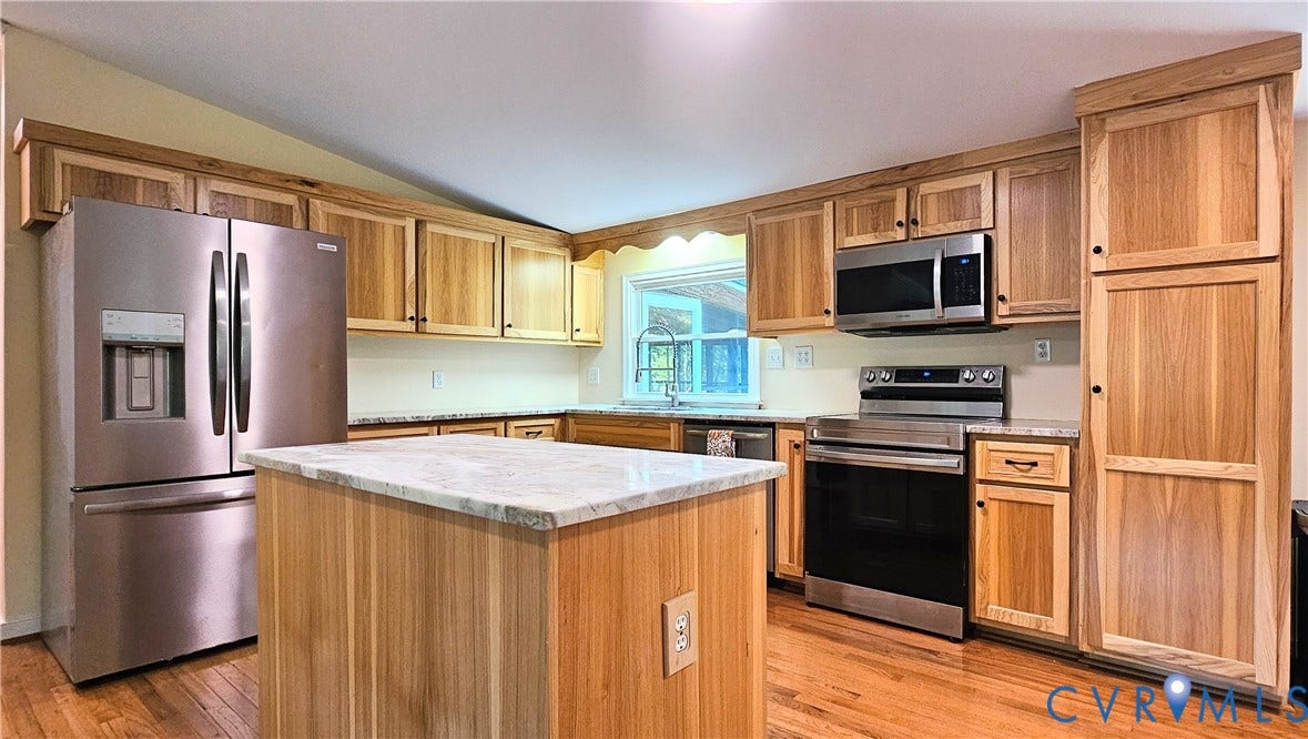24110 Genito Road, Amelia, VA 23002 Kitchen featuring natural wood cabinetry, stone-finish countertops, stainless steel appliances, a center island, and wood-finish flooring