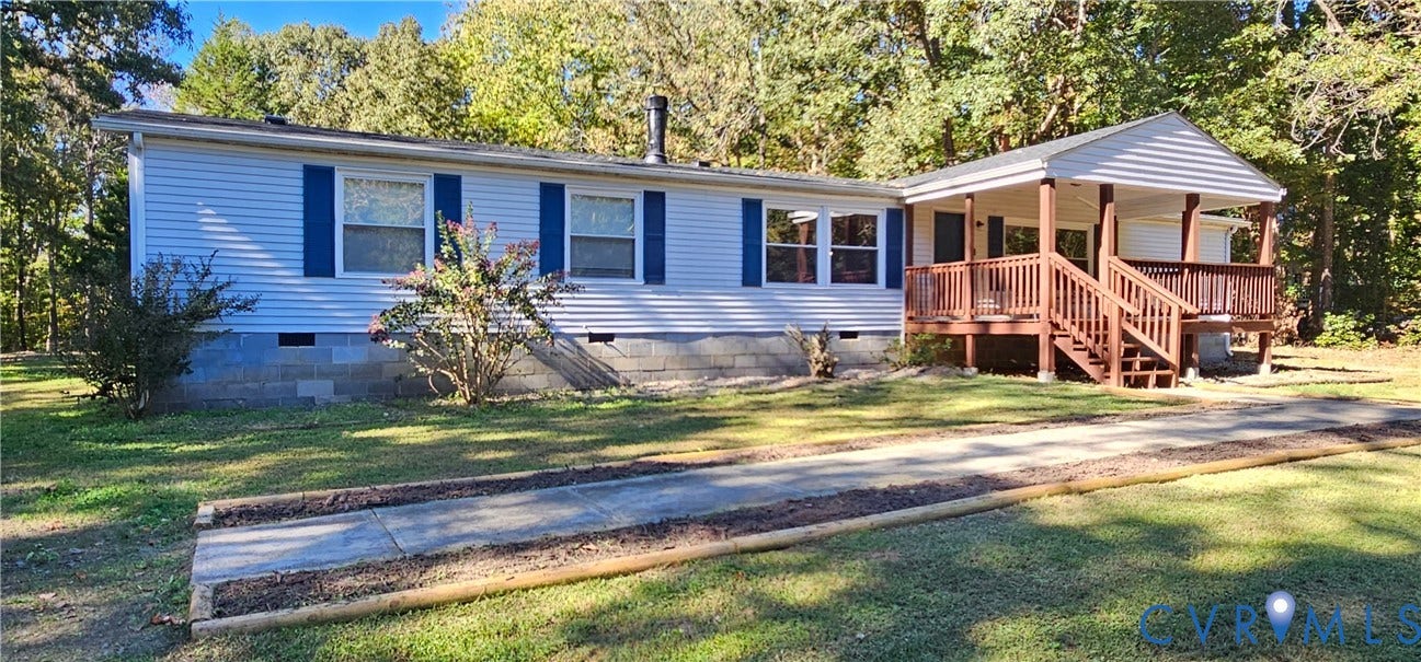 24110 Genito Road, Amelia, VA 23002 Single-story residence featuring horizontal lap siding, blue shutters, a concrete block foundation, and an elevated wooden deck with stairs