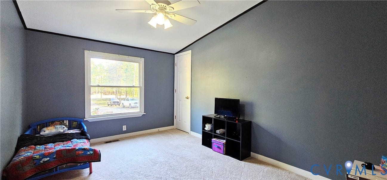 24110 Genito Road, Amelia, VA 23002 Room featuring a vaulted ceiling, neutral wall-to-wall carpeting, and a multi-light ceiling fan