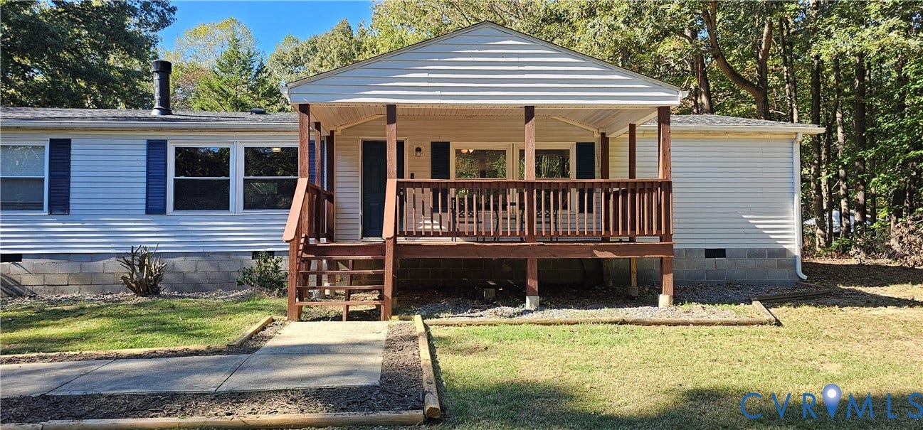 24110 Genito Road, Amelia, VA 23002 Exterior facade featuring horizontal siding, a covered front porch with wooden railings, and a concrete walkway