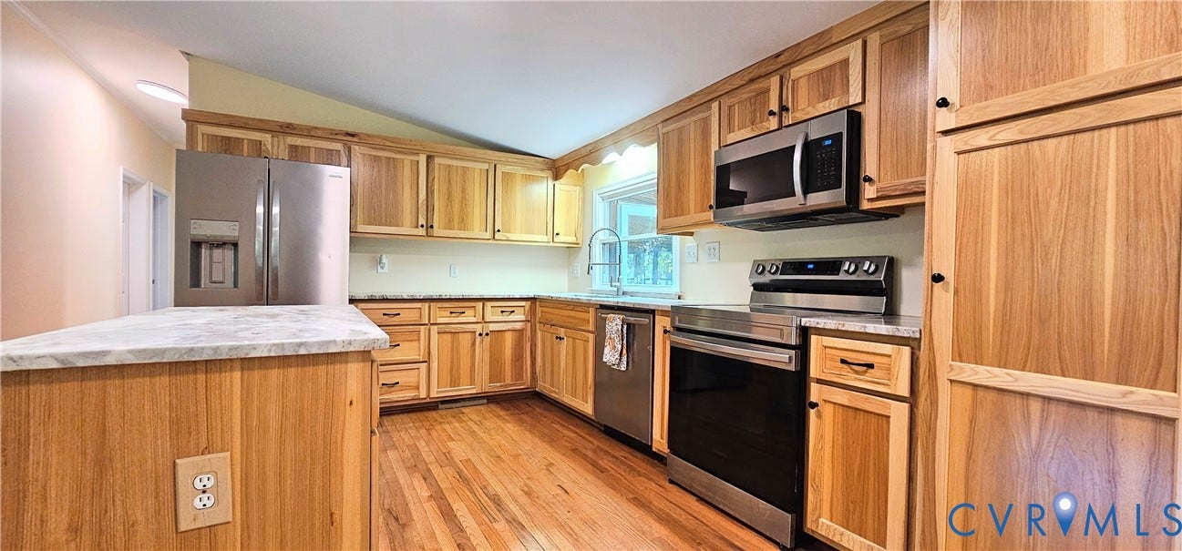 24110 Genito Road, Amelia, VA 23002 Kitchen featuring wood cabinetry, stainless steel appliances, an island with stone-finish countertops, and wood-finish flooring