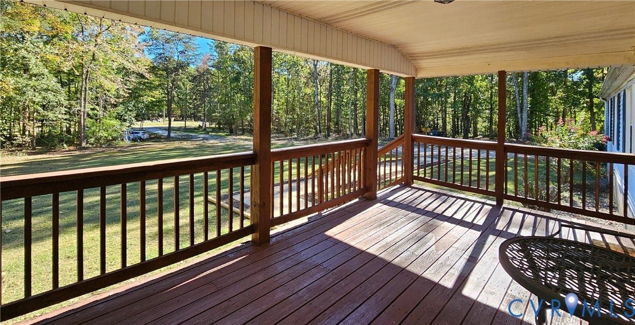 24110 Genito Road, Amelia, VA 23002 Covered rear deck featuring wood decking, wood railing, and a beadboard ceiling