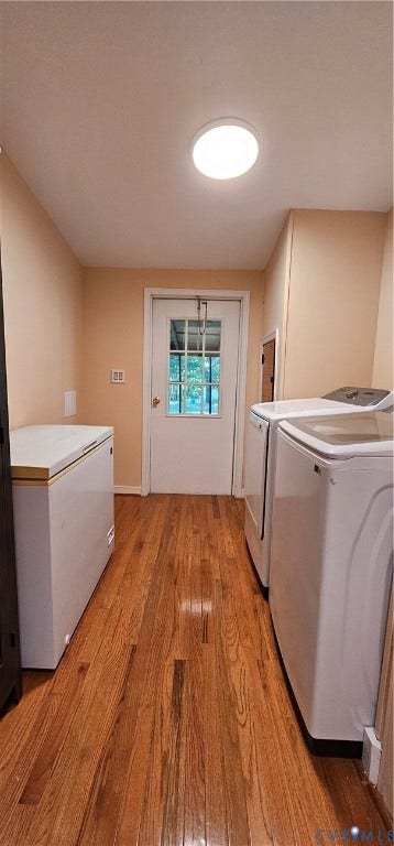 24110 Genito Road, Amelia, VA 23002 Utility room featuring wood-finish flooring, a flush-mount ceiling light, and an exterior door with a window insert