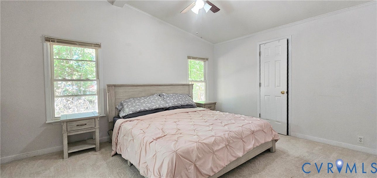 24110 Genito Road, Amelia, VA 23002 Vaulted ceiling featuring a central lighted ceiling fan, neutral wall-to-wall carpeting, two multi-pane windows, and a six-panel interior door