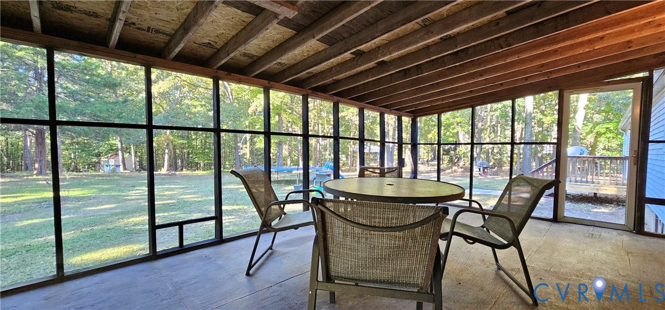 24110 Genito Road, Amelia, VA 23002 Screened-in porch featuring a wood-beam ceiling, full-height window screening, and a solid-surface floor