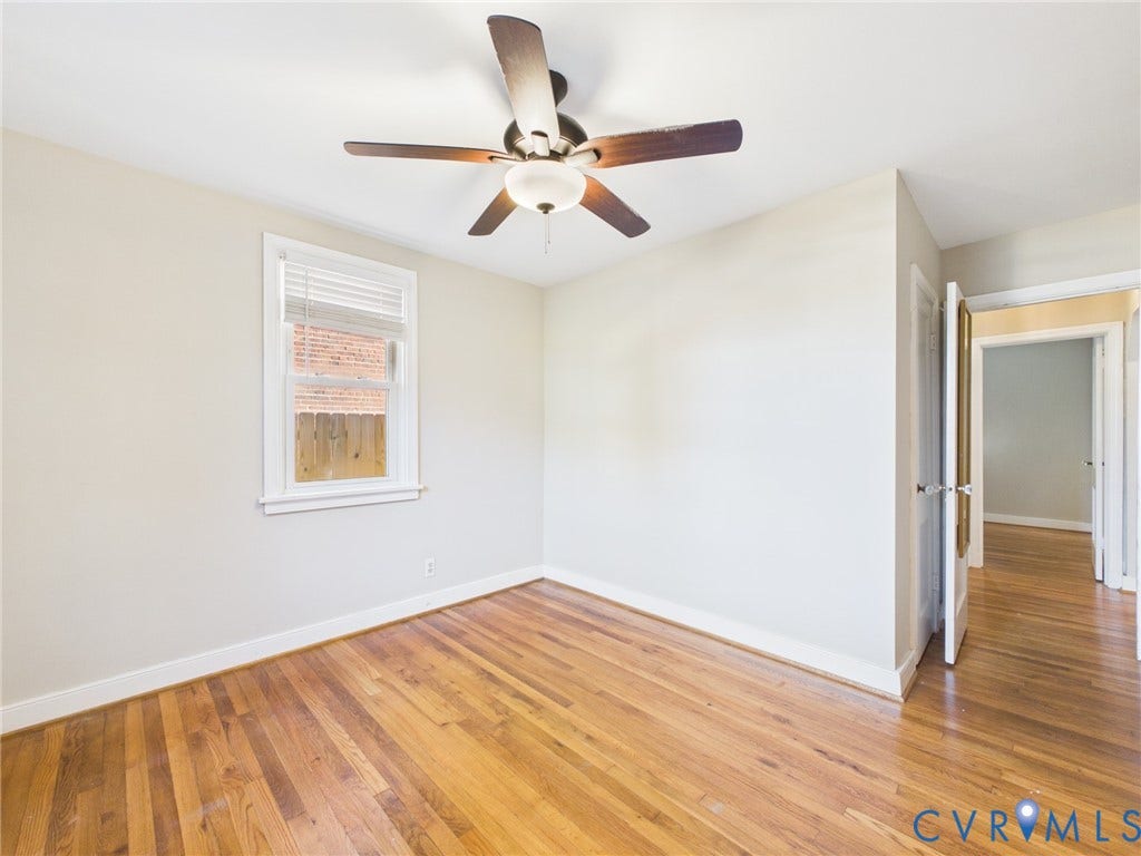 6902 Three Chopt Road, Richmond, VA 23226 Interior room featuring wood-finish flooring, neutral wall paint, and a central ceiling fan with integrated lighting