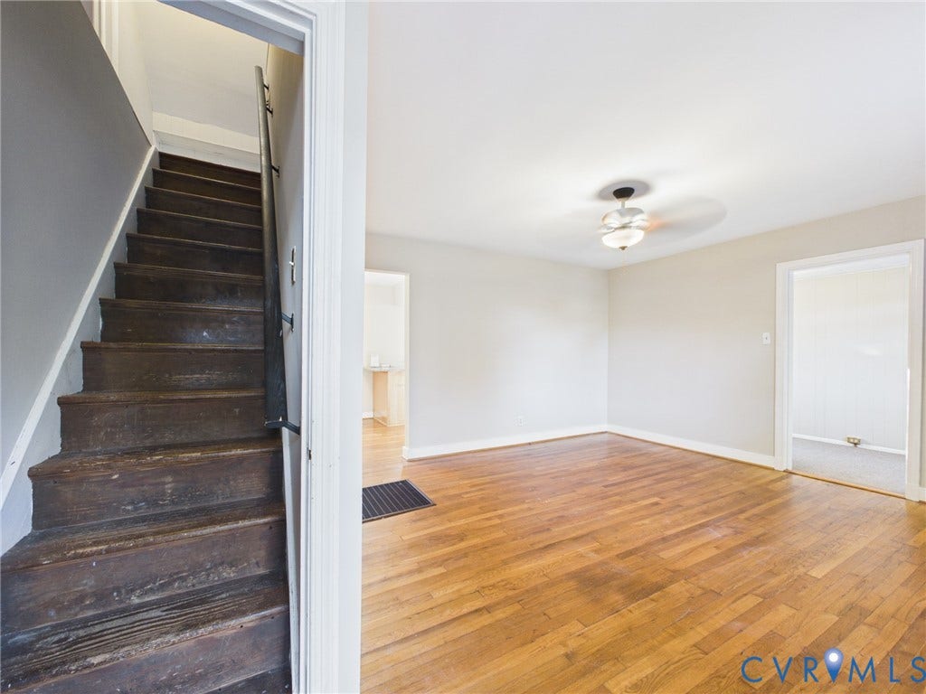 6902 Three Chopt Road, Richmond, VA 23226 Wood-finish flooring, staircase with a metal handrail, ceiling-mounted light fixture with fan, and neutral wall tones