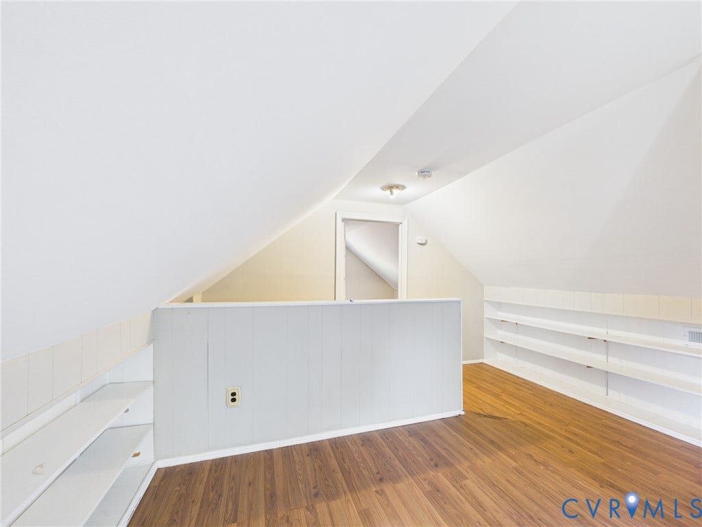 6902 Three Chopt Road, Richmond, VA 23226 Finished attic space featuring vaulted ceilings, wood-finish flooring, and extensive built-in shelving