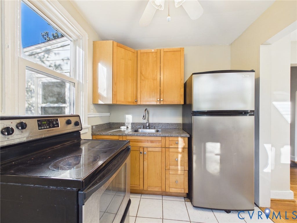 6902 Three Chopt Road, Richmond, VA 23226 Kitchen featuring light wood cabinetry, stone-finish countertops, stainless steel refrigerator, black electric range, and tile flooring