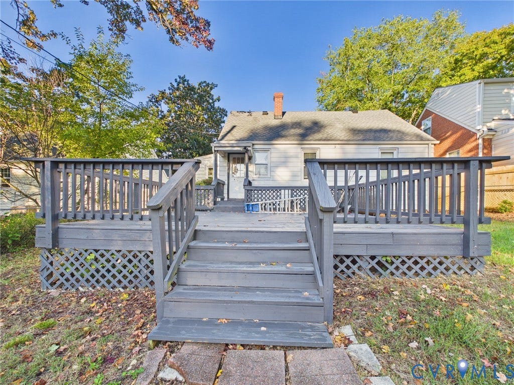 6902 Three Chopt Road, Richmond, VA 23226 Elevated wooden deck featuring railing, lattice skirting, and central stairs leading to the rear exterior of the home