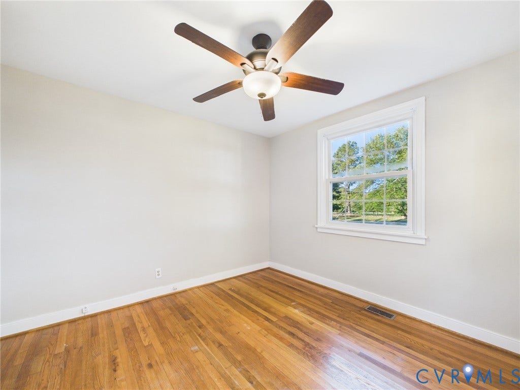 6902 Three Chopt Road, Richmond, VA 23226 Hardwood flooring, multi-pane window with exterior scenery, and ceiling fan with integrated lighting