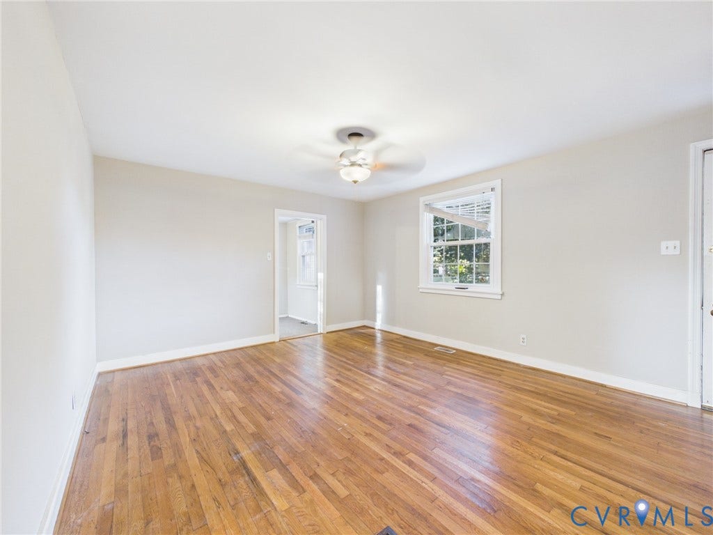 6902 Three Chopt Road, Richmond, VA 23226 Interior room featuring wood-finish flooring, a multi-pane window, and a central ceiling fan with an integrated light fixture
