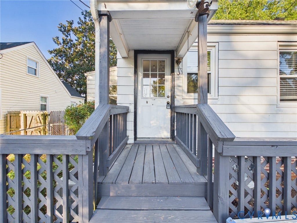 6902 Three Chopt Road, Richmond, VA 23226 Exterior entry featuring horizontal lap siding, a covered porch, wood decking, and decorative lattice railing
