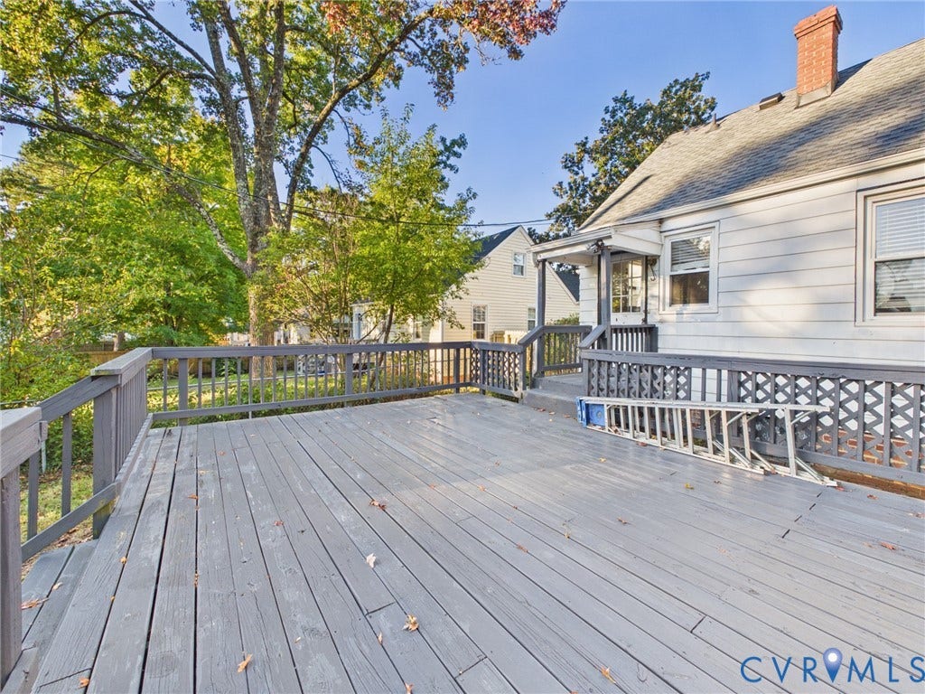 6902 Three Chopt Road, Richmond, VA 23226 Expansive exterior wood deck featuring railing with lattice detailing, horizontal siding, and brick chimney
