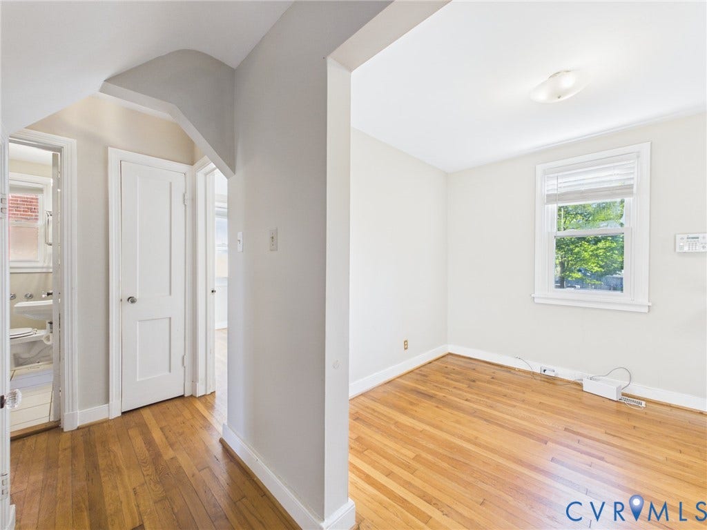 6902 Three Chopt Road, Richmond, VA 23226 Interior space featuring wood-finish flooring, white paneled doors, ceiling-mounted light fixtures, and a window with blinds
