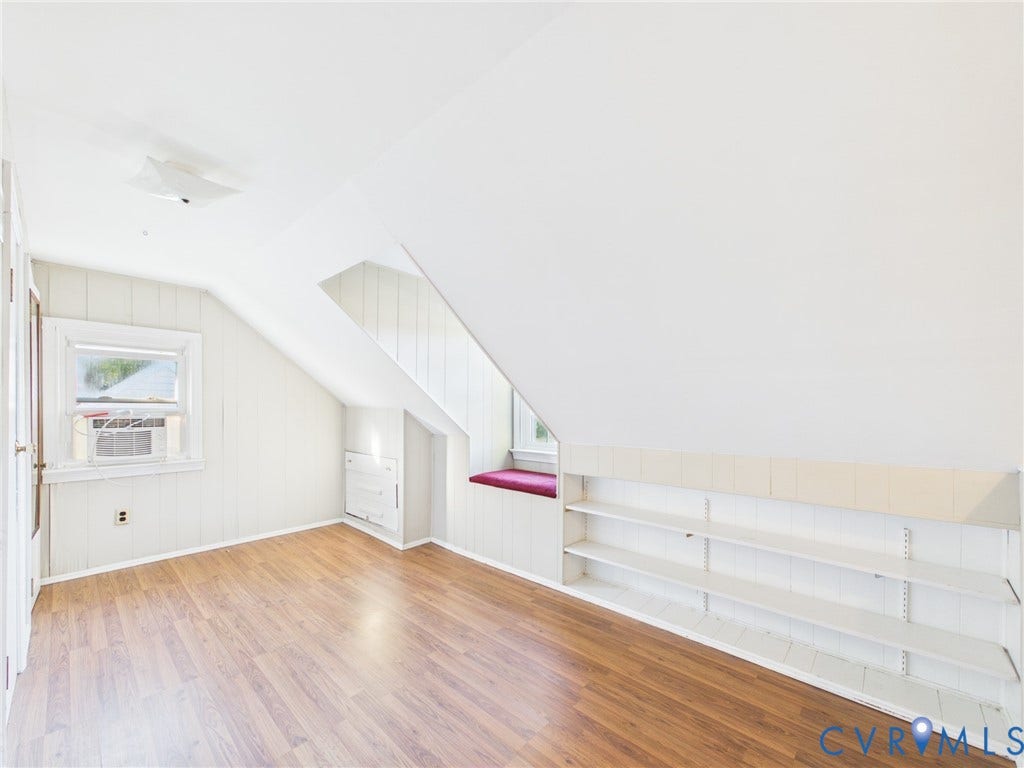 6902 Three Chopt Road, Richmond, VA 23226 Room featuring wood-finish flooring, built-in shelving, vaulted ceilings, and a window seat