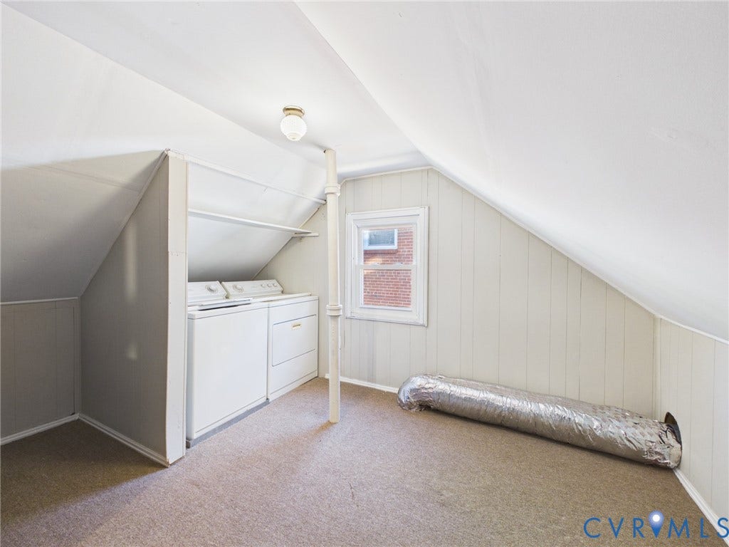 6902 Three Chopt Road, Richmond, VA 23226 Dedicated laundry space featuring built-in cabinetry, vertical support column, single-hung window, and carpeted flooring
