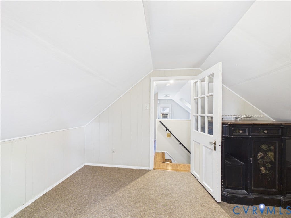 6902 Three Chopt Road, Richmond, VA 23226 Attic space featuring vaulted ceilings, neutral carpeting, and a multi-pane glass door
