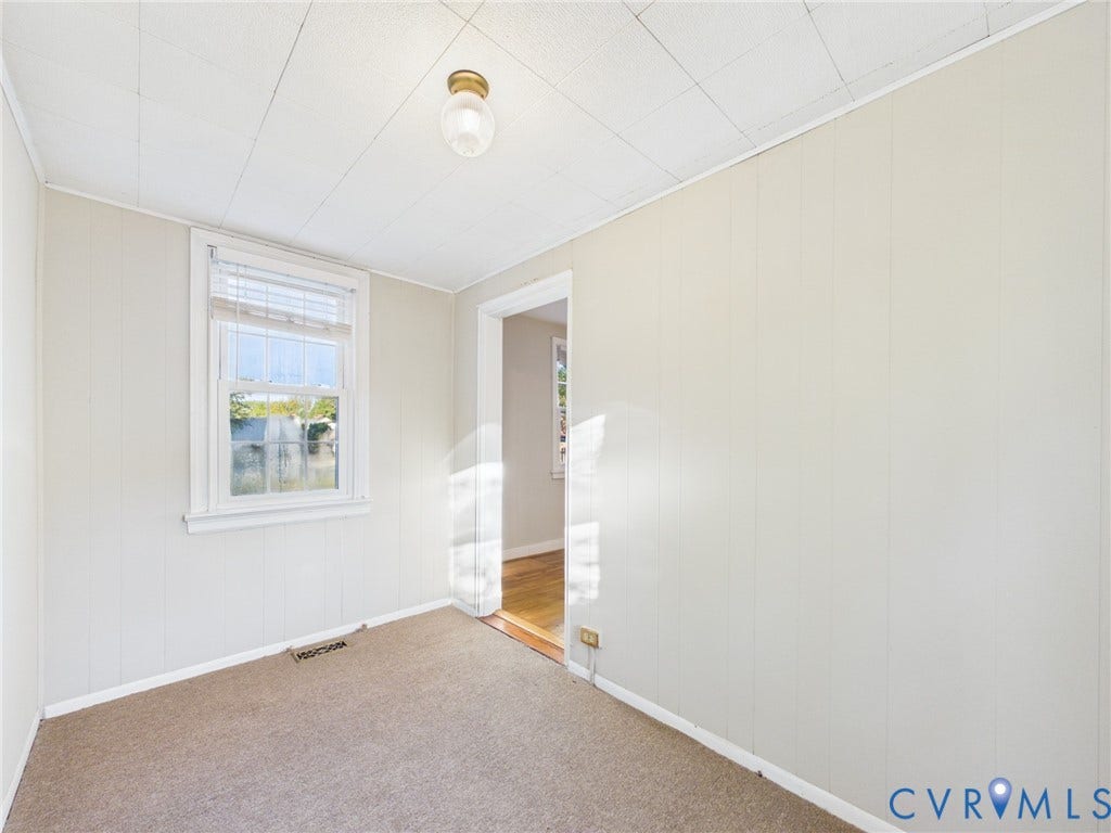 6902 Three Chopt Road, Richmond, VA 23226 Interior room featuring wall paneling, a single-hung window with mini blinds, carpeted flooring, and a flush-mount ceiling light fixture