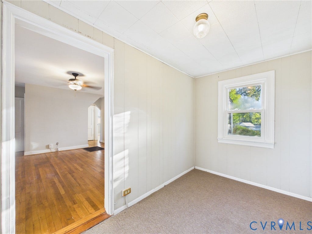 6902 Three Chopt Road, Richmond, VA 23226 Interior room featuring paneling, carpeted flooring, a single-hung window with white casing, and a flush-mount ceiling light fixture