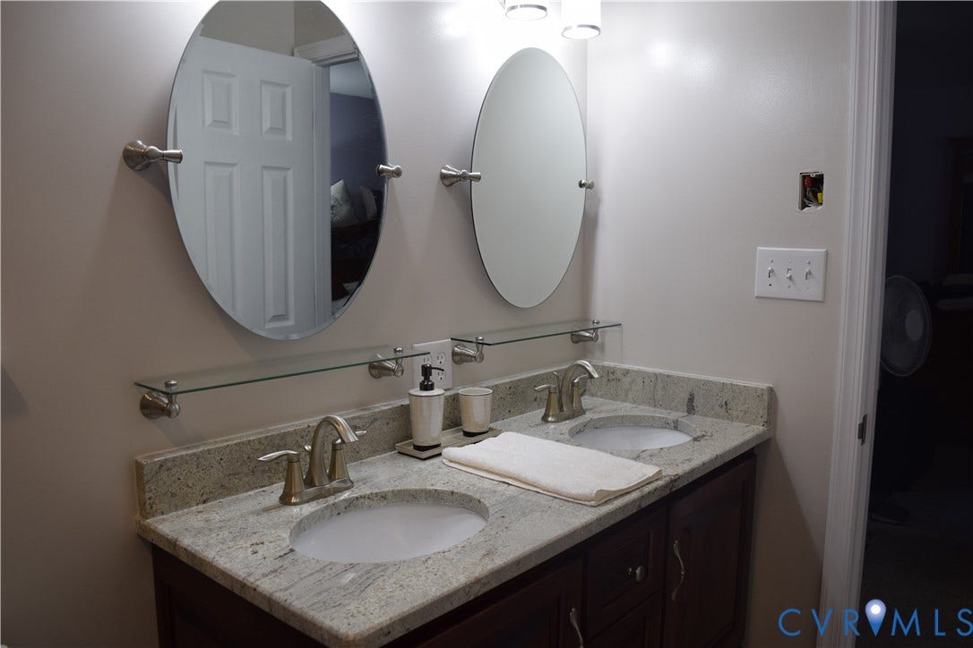 1120 Black Heath Road, Robious/Huguenot, Midlothian, VA 23113 Dual-sink vanity featuring a granite countertop, oval mirrors, glass shelving, and dual-sink custom-height vanity.