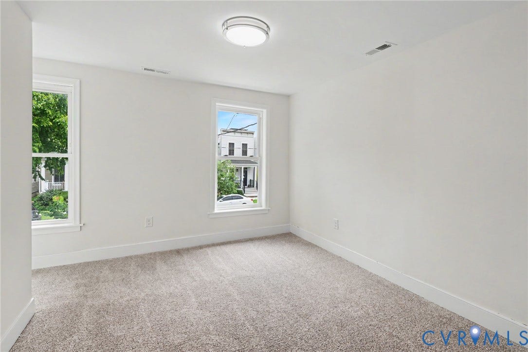 1210 N 24th Street, Church Hill Central, Richmond, VA 23223 Neutral interior room featuring plush carpeting and dual windows with window casing