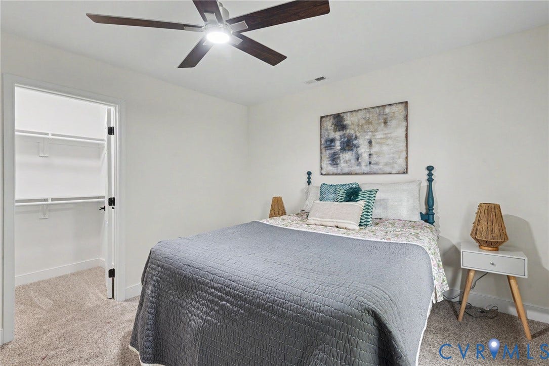 1210 N 24th Street, Church Hill Central, Richmond, VA 23223 Neutral wall color, carpeted flooring, ceiling fan with integrated lighting, and a walk-in closet featuring wire shelving