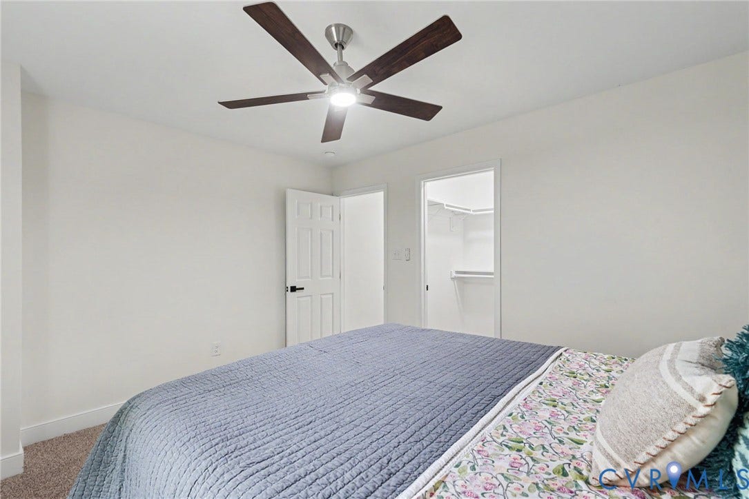 1210 N 24th Street, Church Hill Central, Richmond, VA 23223 Ceiling fan with integrated lighting, neutral wall paint, carpeted flooring, and walk-in closet featuring built-in shelving