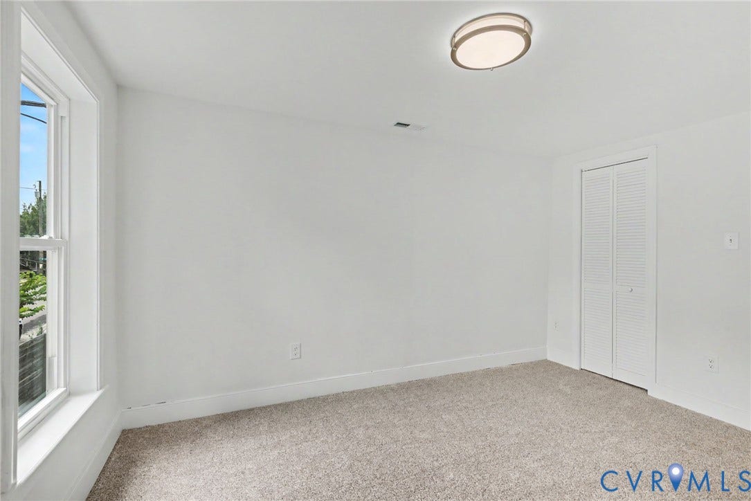 1210 N 24th Street, Church Hill Central, Richmond, VA 23223 Room featuring neutral carpeting, a double-panel bifold closet, and a ceiling-mounted flush mount light fixture