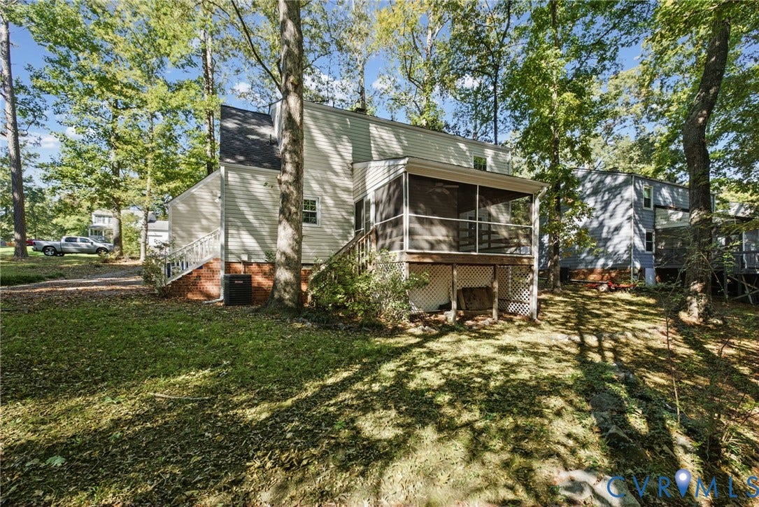 509 Overcliff Court, Walton Park, Midlothian, VA 23114 Exterior featuring light-colored horizontal siding, raised screened porch with wooden railing, lattice foundation skirting, and mature trees
