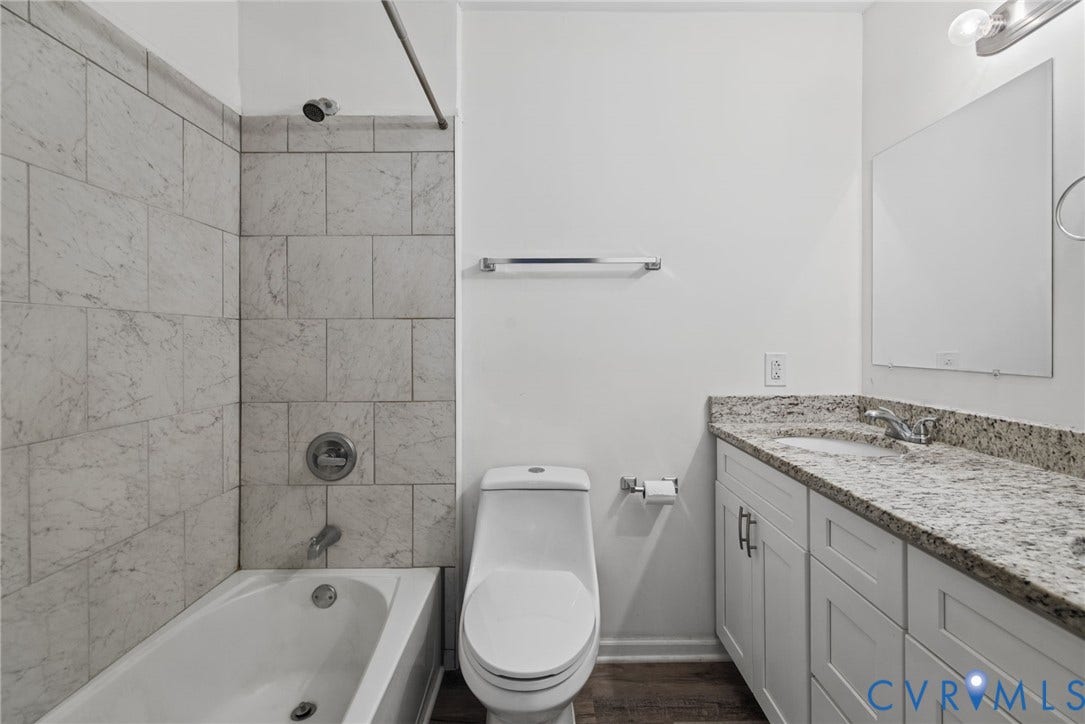 509 Overcliff Court, Walton Park, Midlothian, VA 23114 Bathroom featuring white cabinetry, stone-finish vanity countertop, under-mount sink, chrome fixtures, and a tub-shower combination with floor-to-ceiling tile surround