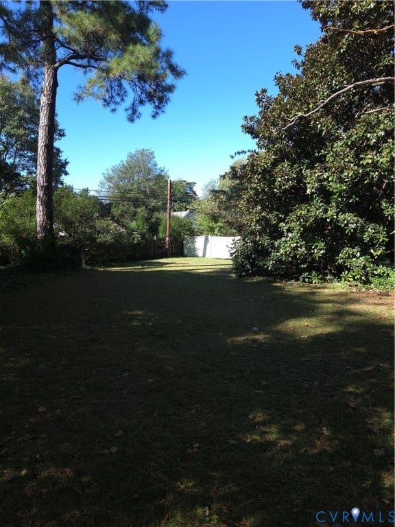 4114 Crestwood Road, Established, Richmond, VA 23227 Expansive backyard featuring a level lawn, mature trees, and perimeter fencing