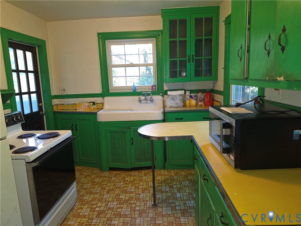 4114 Crestwood Road, Established, Richmond, VA 23227 Kitchen featuring a porcelain apron-front sink, wall-mounted faucet, glass-front upper cabinetry, yellow laminate countertops, and patterned resilient flooring