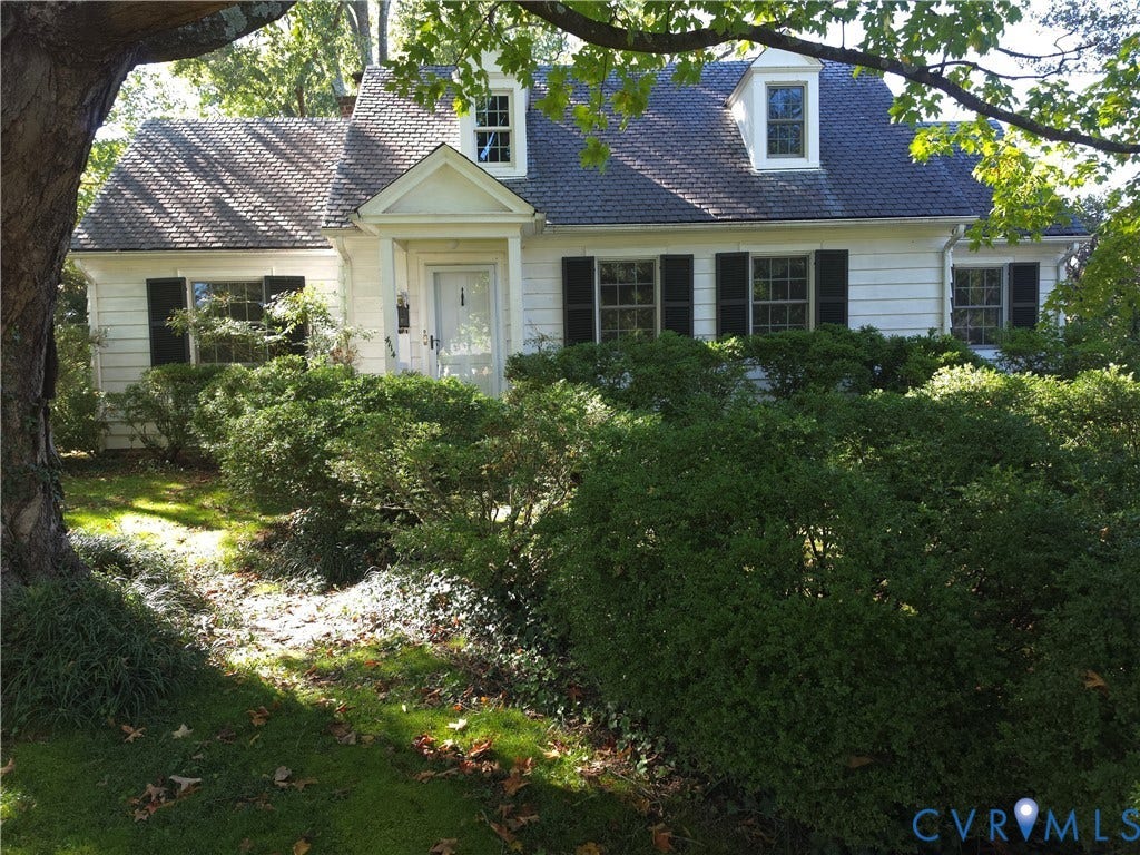 4114 Crestwood Road, Established, Richmond, VA 23227 Cape Cod architecture featuring white siding, dark shutters, two dormer windows, and a covered front entryway