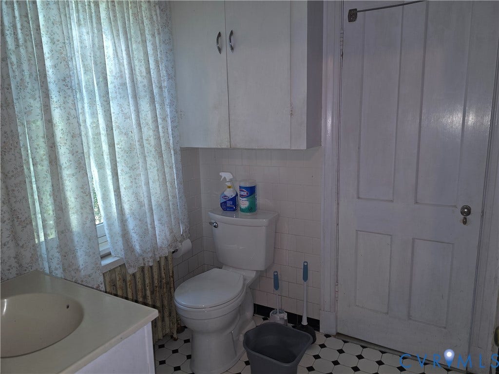 4114 Crestwood Road, Established, Richmond, VA 23227 Wall-mounted cabinetry, square ceramic wall tile, classic hexagonal floor tile, and a four-panel solid wood door