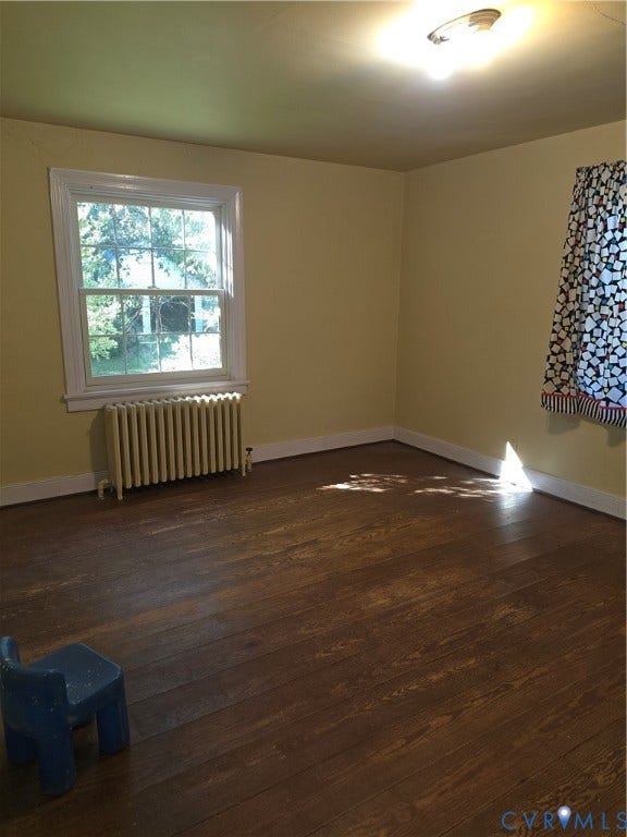 4114 Crestwood Road, Established, Richmond, VA 23227 Room featuring wood-finish flooring, a multi-pane window, and a metal radiator