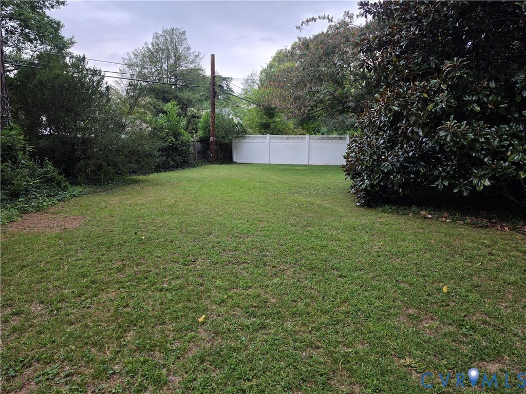 4114 Crestwood Road, Established, Richmond, VA 23227 Expansive backyard featuring a level lawn, mature foliage, and a white privacy fence