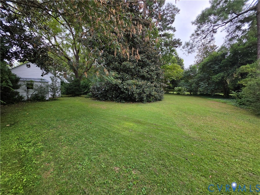 4114 Crestwood Road, Established, Richmond, VA 23227 Expansive backyard featuring mature trees, established landscaping, and white horizontal siding exterior