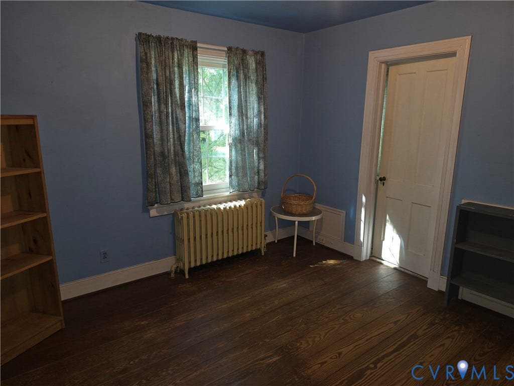 4114 Crestwood Road, Established, Richmond, VA 23227 Wood-finish flooring, single-hung window with wood casing, and a four-panel interior door with traditional hardware